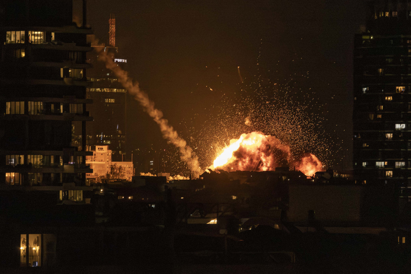 A fireball lights the sky following a missile strike on Tel Aviv on February 28, 2026. The United States and Israel launched strikes against Iran on February 28, with Israel's public broadcaster reporting that the Iranian supreme leader had been targeted, as the Islamic republic retaliated with barrages of missiles at Gulf states and Israel. 