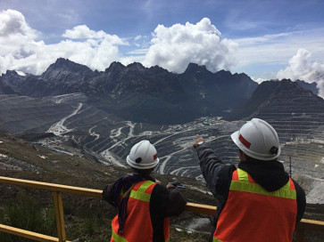 Workers at a mining site of PT Freeport Indonesia look at the Carstensz Pyramid in this undated photograph. 