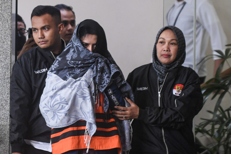 Pekalongan Regent Fadia Arafiq (center) is escorted on March 4, 2026, from of the Corruption Eradication Commission (KPK) building following questioning, in South Jakarta. Fadia was detained by investigators on March 3 for alleged graft involving the procurement of goods and services in Pekalongan.