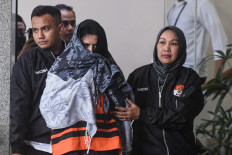 Pekalongan Regent Fadia Arafiq (center) is escorted on March 4, 2026, from of the Corruption Eradication Commission (KPK) building following questioning, in South Jakarta. Fadia was detained by investigators on March 3 for alleged graft involving the procurement of goods and services in Pekalongan.
