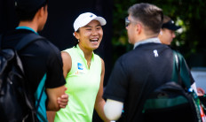 Janice Tjen laughs with her coaches on the sidelines of the Dubai Duty Free Tennis Championships in Dubai, United Arab Emirates, on Feb. 18, 2026.
