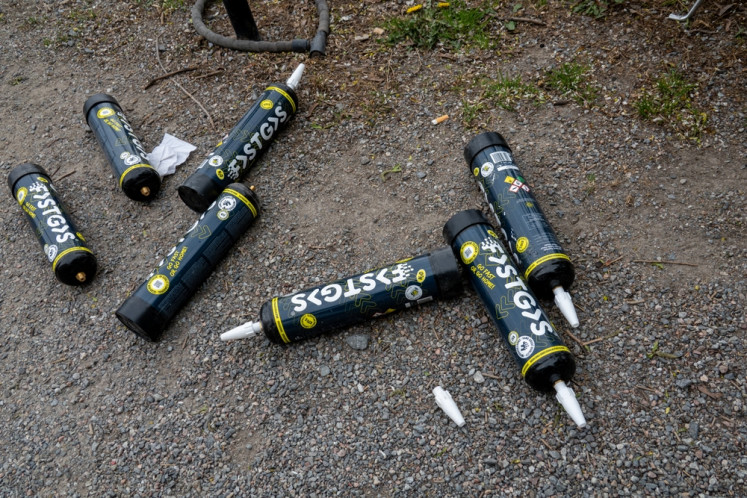 Discarded and empty nitrous oxide canisters are found on the street in Stockholm on May 1, 2025.