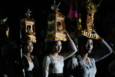 Balinese Hindus take part in a purification ritual known as Melasti on March 8, 2024, before Nyepi, the day of silence that marks the new year in the Balinese Hindu calendar, at Masceti beach in Gianyar, Bali.