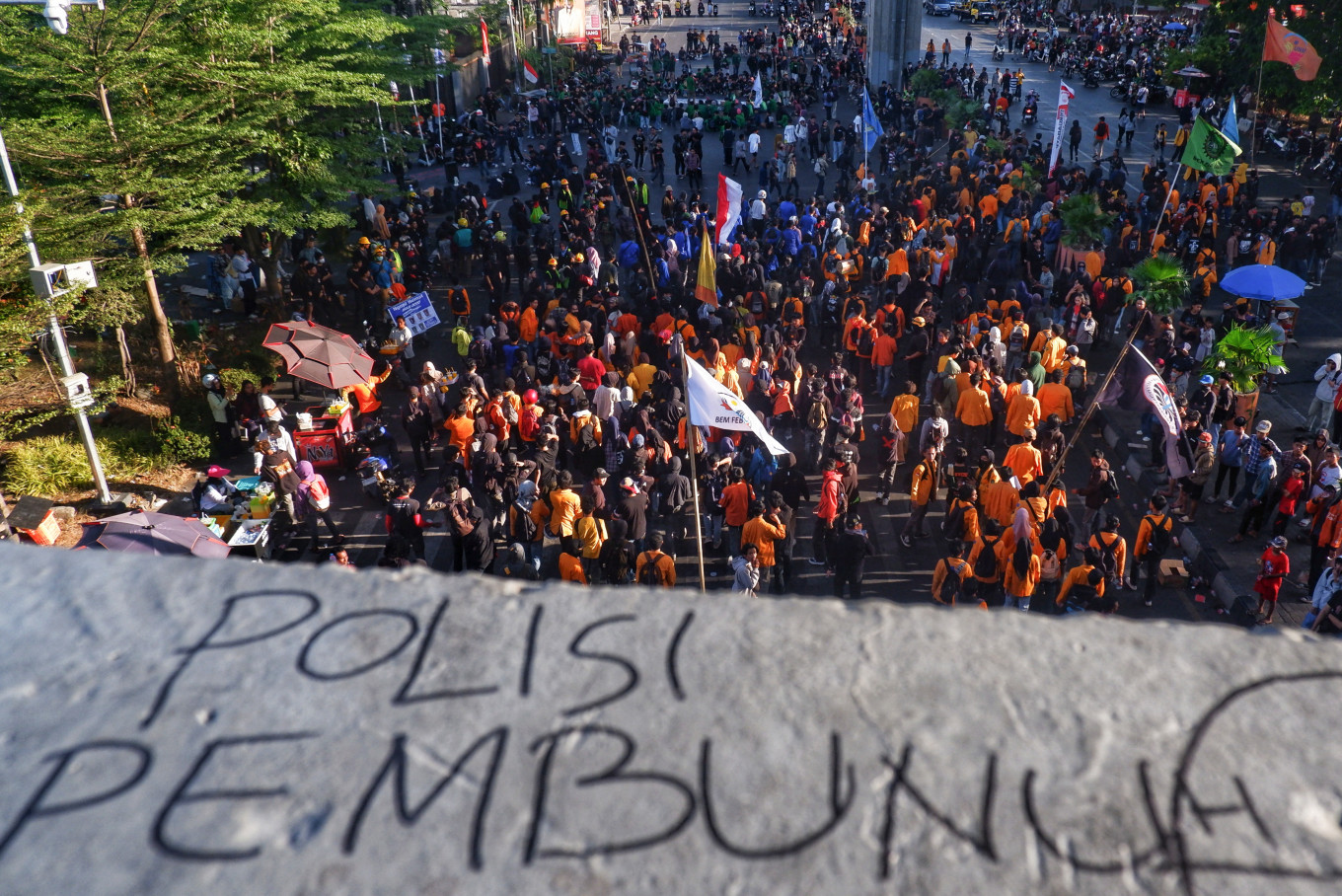 Graffiti that reads &ldquo;police are killers&ldquo; is seen as community groups and university students stage a demonstration on Sept. 1, 2025, demanding an end to police brutality following recent protests, in Makassar, South Sulawesi. Indonesian authorities ramped up security after six people were killed in unrest over economic hardship that escalated into violent anger against the nation's police force.