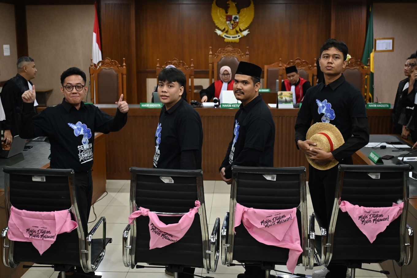 (From left to right) Activists Delpedro Marhaen, Muzaffar Salim, Syahdan Husein and Khariq Anhar pose on March 6, 2026, at the hearing prior to their verdict at Central Jakarta District Court in Jakarta. The judges acquitted the defendants of all incitement charges related to nationwide anti-government protests in August 2025 that later turned into riots.