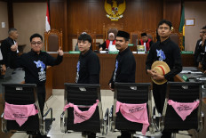 (From left to right) Activists Delpedro Marhaen, Muzaffar Salim, Syahdan Husein and Khariq Anhar pose on March 6, 2026, at the hearing prior to their verdict at Central Jakarta District Court in Jakarta. The judges acquitted the defendants of all incitement charges related to nationwide anti-government protests in August 2025 that later turned into riots.