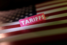 A United States flag and a &ldquo;tariffs&ldquo; label are seen in this illustration taken on April 10, 2025.