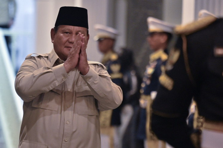 President Prabowo Subianto greets journalists when preparing to welcome former presidents during a high-level briefing on March 3 with top political and business figures on latest geopolitical development at the Presidential Palace Complex in Jakarta.