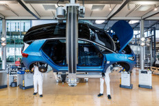 Employees work on the assembly line for the ID.3 electric car of German carmaker Volkswagen, at the 'Glaeserne Manufaktur ( Transparent Factory) production site in Dresden, eastern Germany, on May 14, 2025.