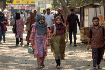This photograph taken on February 5, 2026 shows Dhaka University students walking inside the university's campus in Dhaka. 
