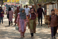 This photograph taken on February 5, 2026 shows Dhaka University students walking inside the university's campus in Dhaka. 