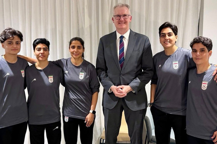 An undated and unplaced photo released by Australia's Department of Home Affairs shows Home Affairs Minister Tony Burke (third from right) with five Iranian women football players who applied for asylum after competing in the Women's Asia Cup tournament being played in Australia. Australia has granted asylum to some of Iran's visiting women's football team over fears they faced persecution at home for not singing the national anthem before a match, Home Affairs Minister Tony Burke said on Tuesday. 