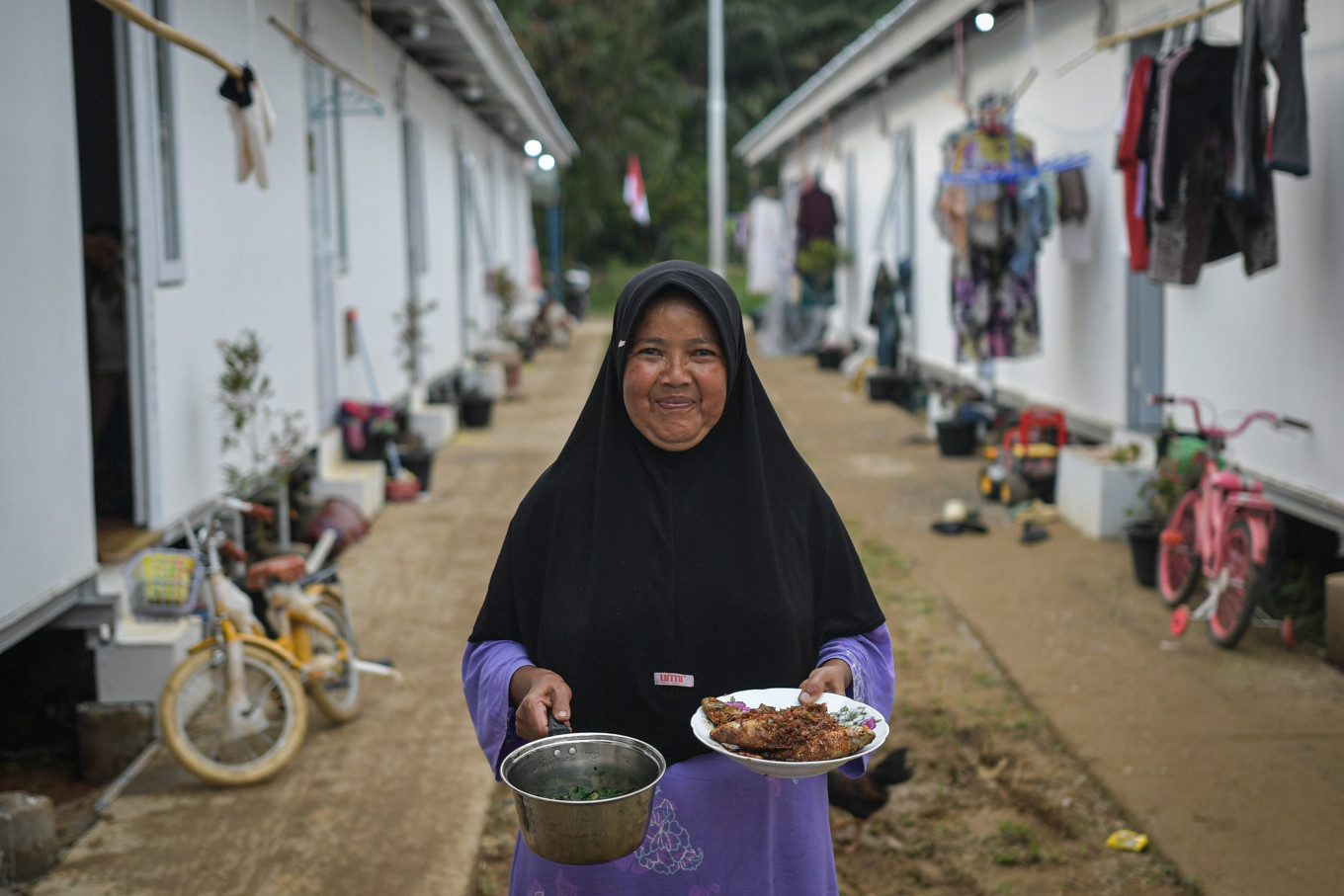 Residents prepare meals for iftar at the Simarpinggan temporary housing complex in South Tapanuli, North Sumatra, on Feb. 19, 2026. A total of 186 households displaced by landslides in Tandihat village broke their fast at the complex.