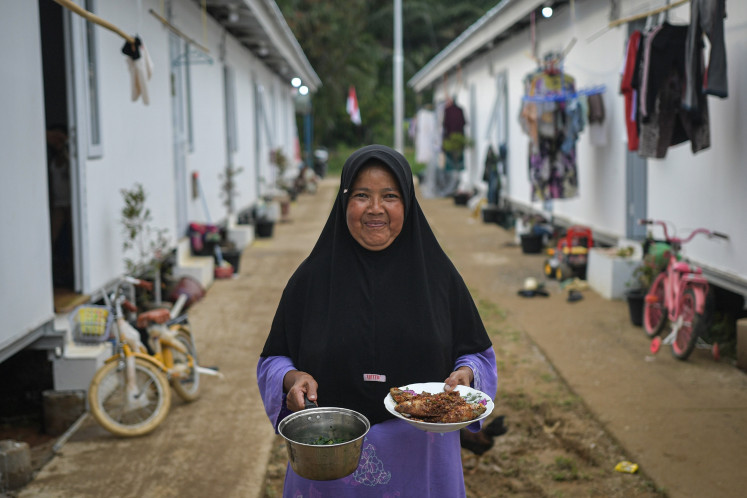 Residents prepare meals for iftar at the Simarpinggan temporary housing complex in South Tapanuli, North Sumatra, on Feb. 19, 2026. A total of 186 households displaced by landslides in Tandihat village broke their fast at the complex.