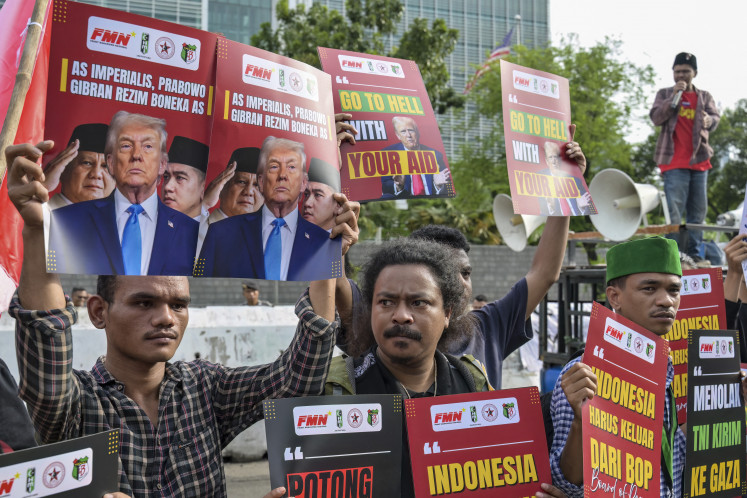 Dozens of protesters hold a rally to condemn United States and Israeli attacks on Iran and Palestinians while holding posters reading 'US Imperialists, President Prabowo Subianto and Vice President Gibran Rakabuming Raka are a US puppet regime' on March 3 in front of the US Embassy in Jakarta.