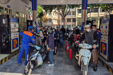 People queue to buy petrol at a petrol station after Vietnam's trade ministry called on local businesses to encourage their employees to work from home to save fuel amid disruptions in supply and price surges triggered by the US-Israeli conflict with Iran, in Hanoi, Vietnam on March 10, 2026.