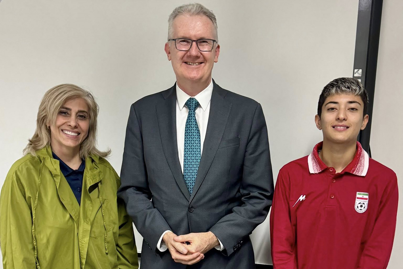 An undated photo released by Australia's Department of Home Affairs on March 11, 2026 shows Australia's Home Affairs Minister Tony Burke (center) with Iranian women's football team player Mohaddeseh Zolfi (right) and support member Zahra Soltan Meshkeh Kar (left) in Sydney, after they claimed asylum in Australia.