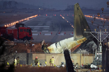 In this file photo dated Dec. 30, 2024, rescuers work near the wreckage of the Jeju Air aircraft that went off the runway and crashed at Muan International Airport in Muan, South Korea.