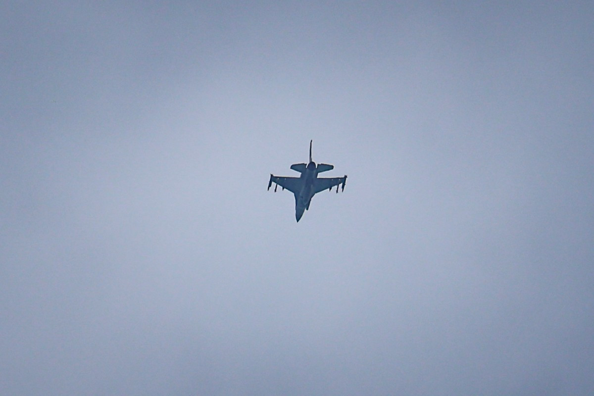 A United Arab Emirates Air Force F-16 fighter jet flies over Dubai on March 11, 2026. The Gulf countries have long been seen as islands of stability in the Middle East, but the war in the region could threaten their prosperity, analysts said, pointing to risks to their revenues and reputations as business havens. 