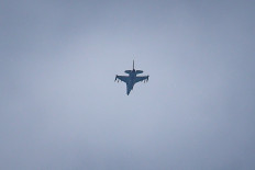 A United Arab Emirates Air Force F-16 fighter jet flies over Dubai on March 11, 2026. The Gulf countries have long been seen as islands of stability in the Middle East, but the war in the region could threaten their prosperity, analysts said, pointing to risks to their revenues and reputations as business havens. 
