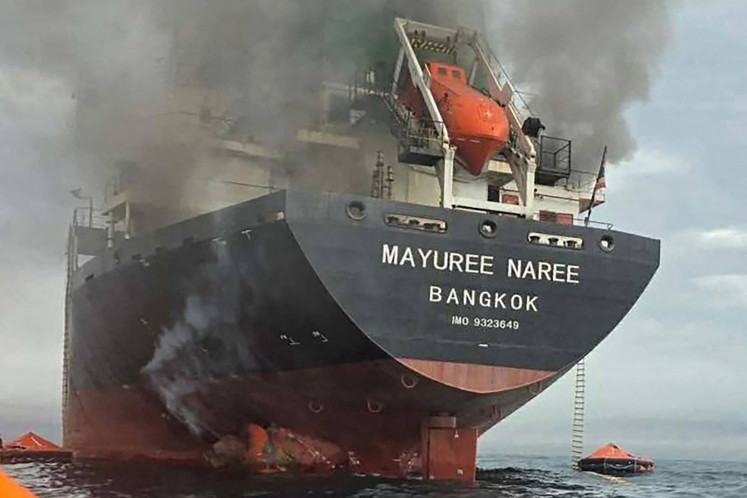 This handout photo taken on March 11, 2026 and released by the Royal Thai Navy shows smoke rising from the Thai bulk carrier 'Mayuree Naree' near the Strait of Hormuz after an attack. A Thai bulk carrier traveling in the crucial Strait of Hormuz was attacked March 11, with 20 crew members rescued so far, the Thai navy said.