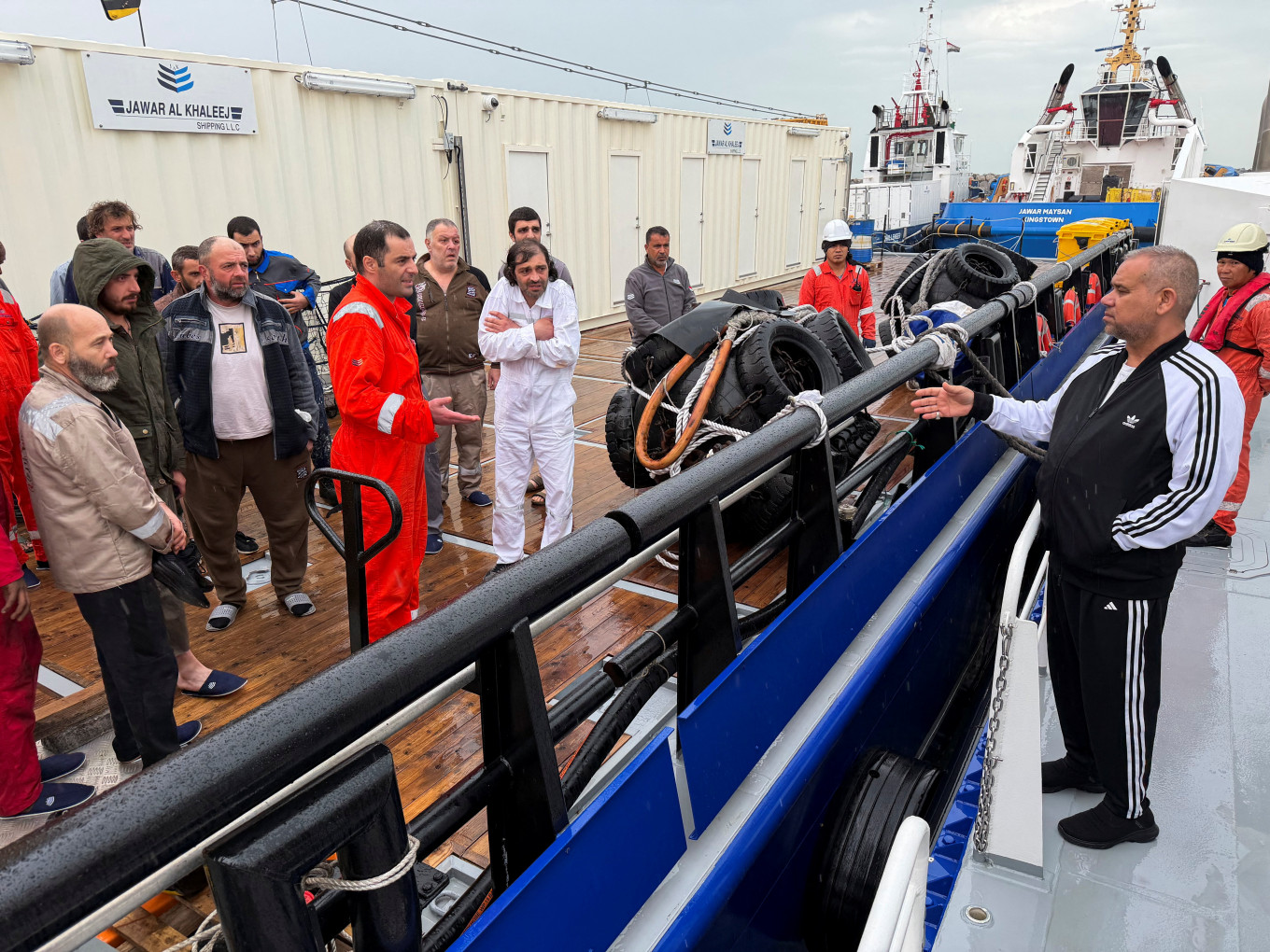 Iraq's director general of the General Company for Ports Farhan al-Fartousi interacts with rescued crew members from the fuel tanker Zephyros, who are aboard an Iraqi vessel following an apparent attack on the tanker in Iraqi waters, according to port and maritime security sources, amid the US-Israeli conflict with Iran, at the port of Faw, Basra, Iraq, on March 12, 2026. 