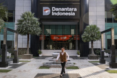 An employee walks in the courtyard of Wisma Danantara Indonesia, Jakarta, on Sept. 8, 2025. 