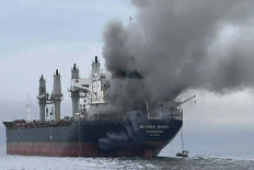This handout photo taken on March 11, 2026 and released by the Royal Thai Navy shows smoke rising from the Thai bulk carrier 'Mayuree Naree' near the Strait of Hormuz after an attack. A Thai bulk carrier traveling in the crucial Strait of Hormuz was attacked March 11, with 20 crew members rescued so far, the Thai navy said. 