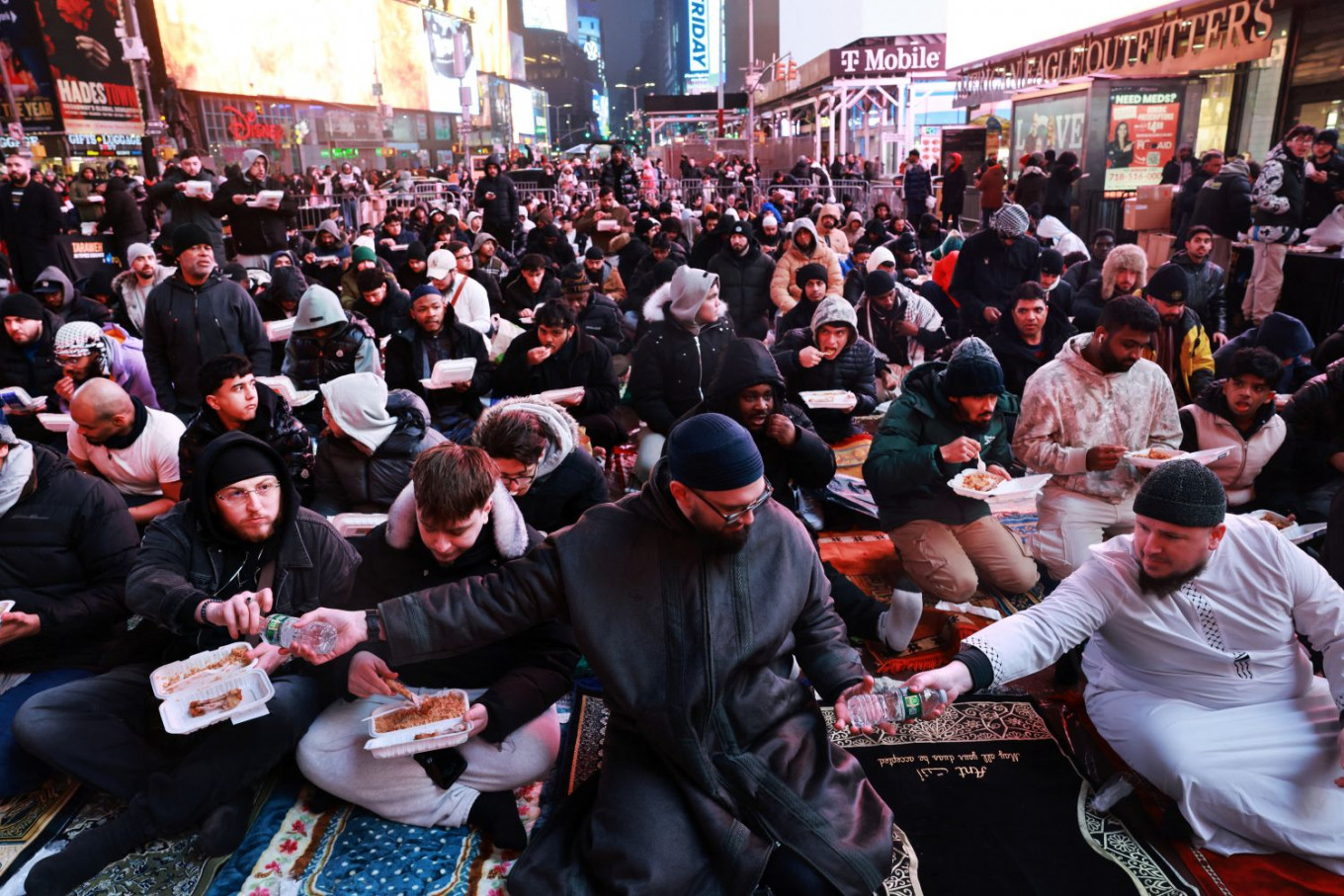 Giving season: Muslims share food and drinks during iftar on Feb. 20, 2026, as they gather to perform the tarawih (Ramadan evening prayers) at Times Square in New York City, the United States. 