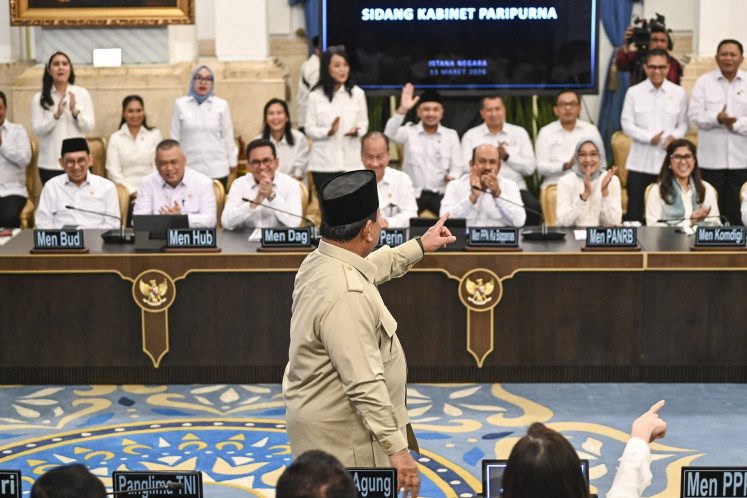 President Prabowo Subianto (center) points to his ministers on Friday ahead of a plenary cabinet meeting to discuss the government's preparation ahead of the Idul Fitri holiday and response to the ongoing conflict in the Middle East at the State Palace in Jakarta.