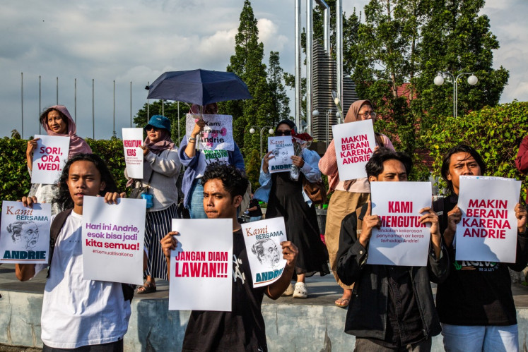 Activists hold posters during a demonstration in support of Andrie Yunus, a staff member of the human rights NGO KONTRAS (Commission for Missing Persons and Victims of Violence), who was attacked with acid by an unidentified person, in Yogyakarta, March 14, 2026. 