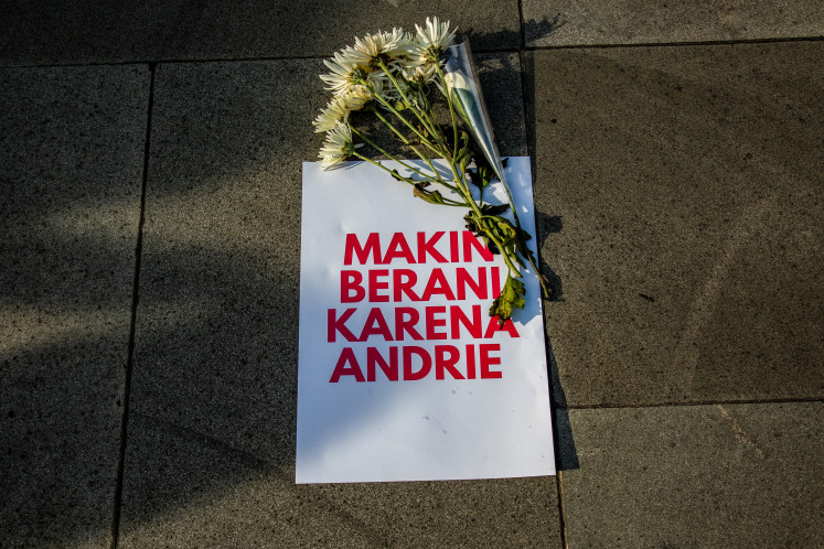 A poster reading "braver because of Andrie" with flowers is seen during a demonstration on March 14 in Yogyakarta in support of activist Andrie Yunus of the Commission for Missing Persons and Victims of Violence (Kontras), who was attacked with acid by unidentified persons.