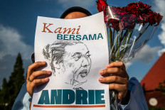 Support and empathy: A man holds a poster during a demonstration in Yogyakarta on March 14, 2026, expressing solidarity with Andrie Yunus, a rights advocate with the Commission for Missing Persons and Victims of Violence (Kontras) who was targeted in an acid attack perpetrated by unknown individuals on March 12 in Central Jakarta.