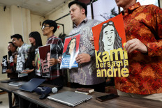 Advocacy for Democracy Team (TAUD) members hold posters on Monday in solidarity with Andrie Yunus, an activist and deputy coordinator with rights group Commission for Missing Persons and Victims of Violence (Kontras), who suffered burns to 24 percent of his face and arms from acid thrown by two unidentified assailants on a motorcycle on Thursday after a press conference in Jakarta, Indonesia. 
