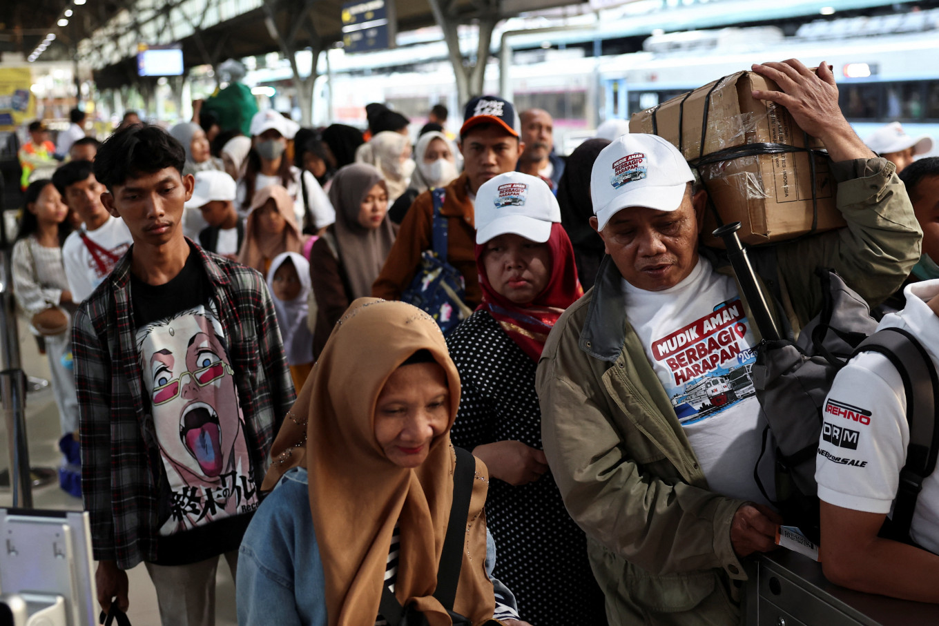 Homeward bound: Passengers carrying luggage line up on March 16 at Pasar Senen train station in Central Jakarta as they prepare to travel to their hometowns as part of the Idul Fitri holiday mudik (exodus). 