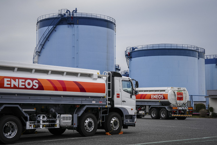 Trucks are seen at an oil terminal in Yokohama, Kanagawa prefecture on March 17, 2026. Oil prices resumed their push higher on March 17 as several countries pushed back against Donald Trump's demand that they help secure the key Strait of Hormuz, while Iran continued to target crude-producing neighbors in retaliation for attacks against it.
