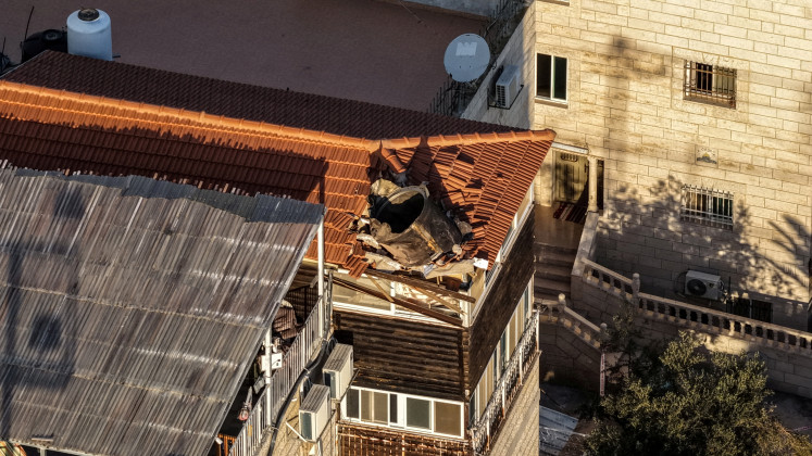 A drone view shows part of an Iranian missile that landed on a building's roof, amid the US-Israel conflict with Iran, in East Jerusalem March 16, 2026. 