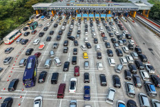 Vehicles are seen stuck in traffic on Tuesday on the toll road heading out of Jakarta at the Cikampek Utama toll booth in Cikampek, West Java, as people head to their hometowns for the upcoming Idul Fitri holiday, which marks the end of the Islamic holy fasting month of Ramadan.