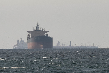 In this file photo dated March 11, 2026, cargo ships in the Gulf, near the Strait of Hormuz, as seen from northern Ras al-Khaimah, near the border with Oman&rsquo;s Musandam governance, amid the US-Israeli conflict with Iran, in the United Arab Emirates.