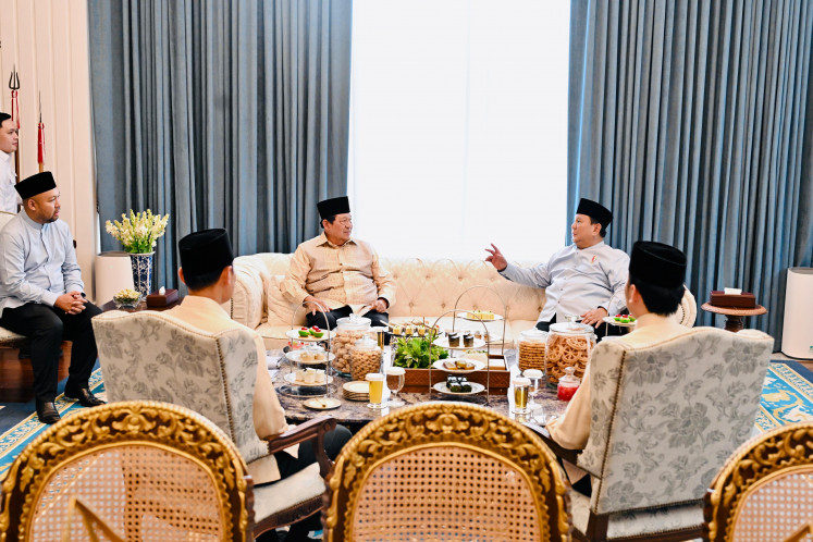 President Prabowo Subianto (right, rear), accompanied by his son Ragowo &ldquo;Didit&rdquo; Hediprasetyo (left, seated), speaks with former president Susilo Bambang Yudhoyono (center) on Saturday, during a private meeting on the sidelines of the Idul Fitri open house at the Merdeka Palace in Central Jakarta.