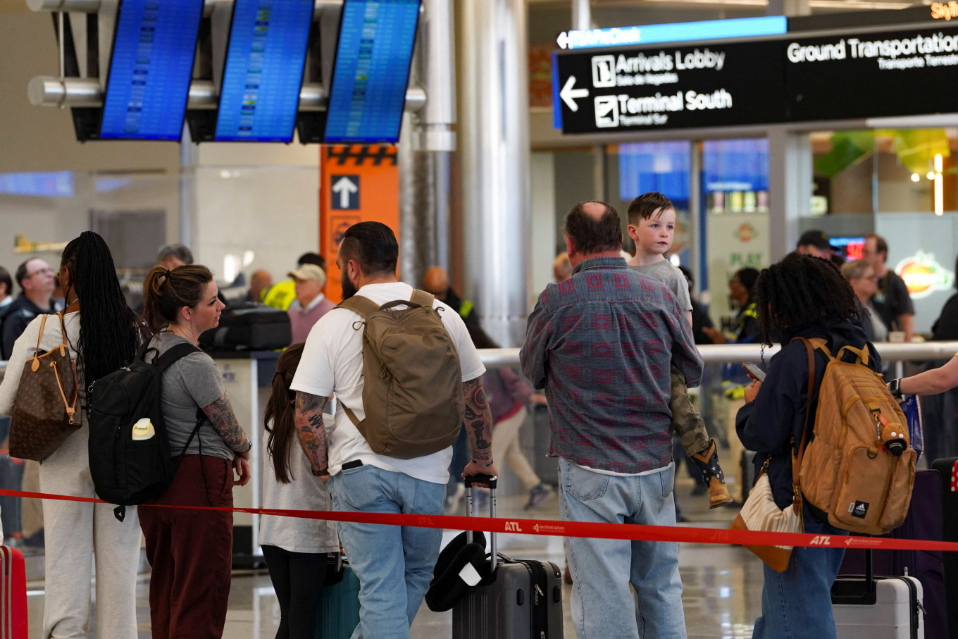 Passengers wait in long TSA lines as a partial government shutdown continues, at Hartsfield-Jackson Atlanta International Airport in Atlanta, Georgia, US on March 20, 2026. 