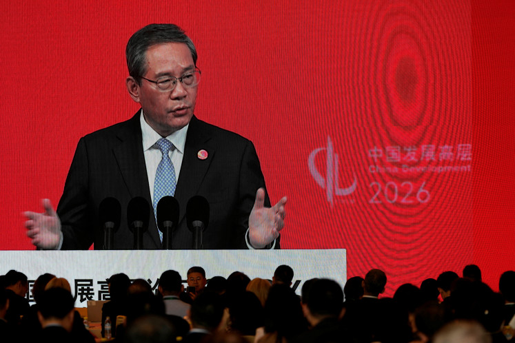 Chinese Premier Li Qiang on a big screen live broadcasting his speech at the opening of the China Development Forum 2026 held at the Diaoyutai State Guesthouse in Beijing, China, March 22, 2026. 