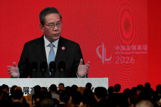 Chinese Premier Li Qiang on a big screen live broadcasting his speech at the opening of the China Development Forum 2026 held at the Diaoyutai State Guesthouse in Beijing, China, March 22, 2026. 