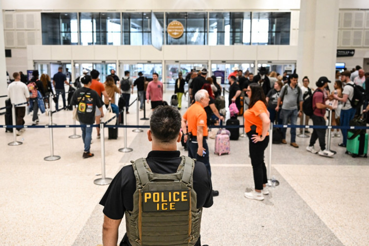 US Immigration and Customs Enforcement (ICE) are seen at George Bush Intercontinental Airport in Houston, Texas on March 23, 2026.