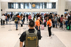 US Immigration and Customs Enforcement (ICE) are seen at George Bush Intercontinental Airport in Houston, Texas on March 23, 2026.