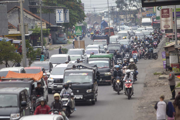 Congested vehicles line up on a road in Palimanan in Cirebon, West Java on March 23, 2026, as people head back to Greater Jakarta following the Idul Fitri holiday.