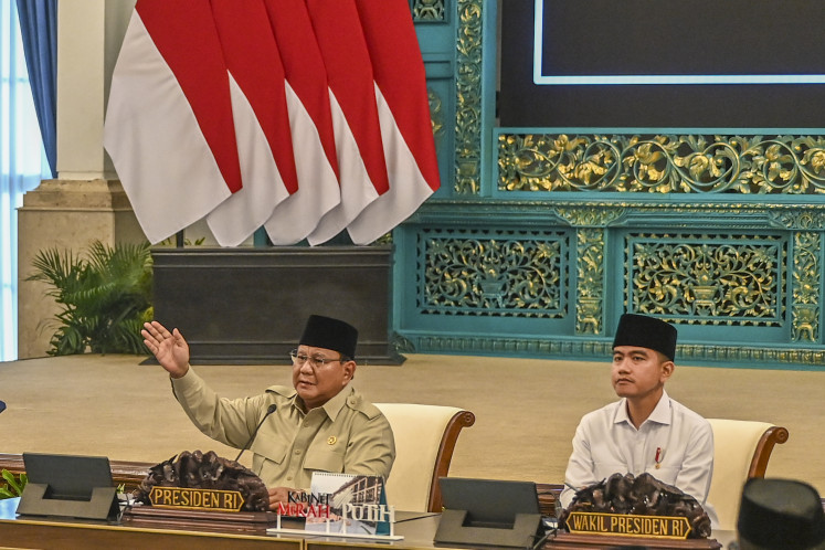 Presidential gesture: President Prabowo Subianto (left), accompanied by Vice President Gibran Rakabuming Raka, leads on March 13, 2026, a plenary cabinet meeting at the State Palace in Central Jakarta.