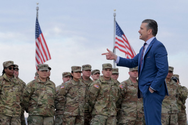 US Secretary of War Pete Hegseth address a group of National Guard troops before administering their re-enlistment ceremony at the base of the Washington Monument on February 06, 2026 in Washington, DC. 