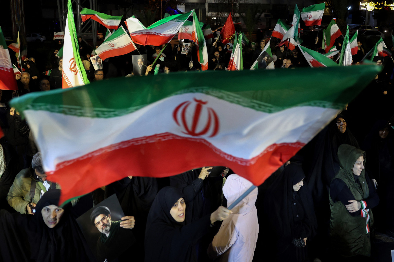 War-time march: People wave national flags and hold portraits of Iran&rsquo;s supreme leader Mojtaba Khamenei on Wednesday, March 25, 2026, as they march in support of the Iranian armed forces in central Tehran.