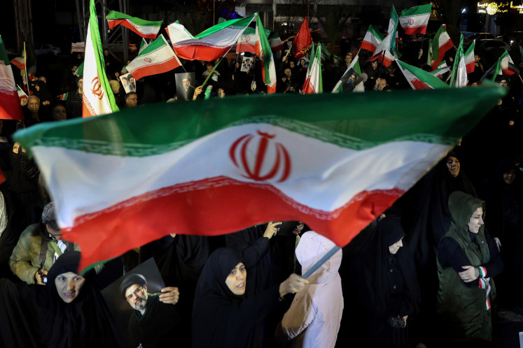 War-time march: People wave national flags and hold portraits of Iran&rsquo;s supreme leader Mojtaba Khamenei on Wednesday, March 25, 2026, as they march in support of the Iranian armed forces in central Tehran.